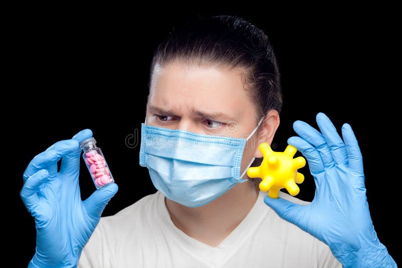 Infectious disease specialist in a medical mask and sterile blue gloves.