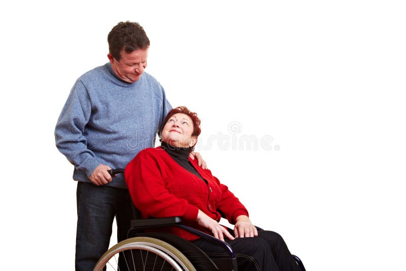 Male nurse caring for disabled senior woman in wheelchair. Male nurse caring for disabled senior woman in wheelchair