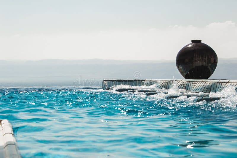 Infinity pool jacuzzi with azure water. Luxury lifestyle, spa concept.