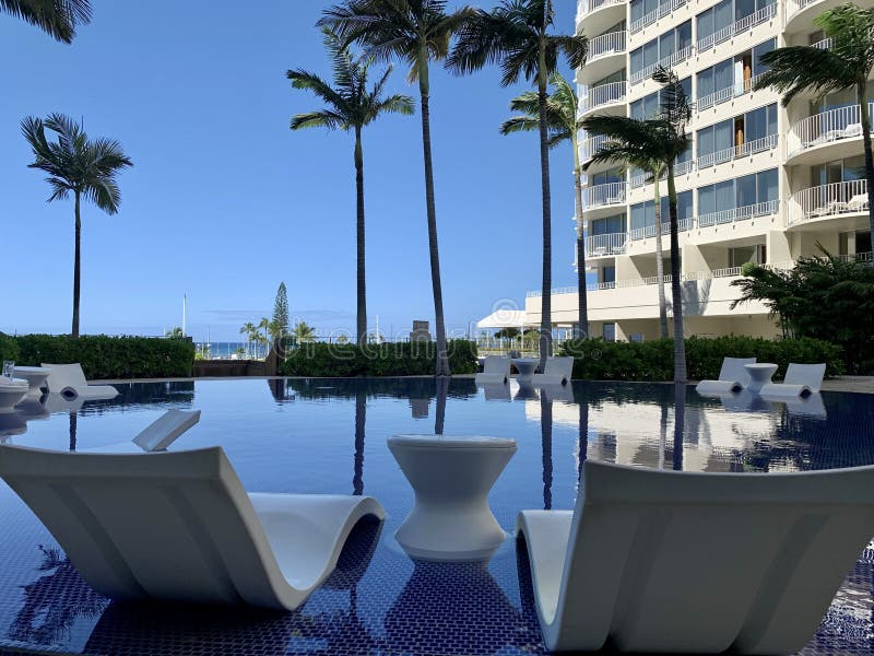 Infinity Pool with Resting Chairs and Tables in a Resort in Honolulu