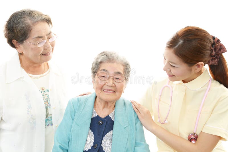 Friendly nurse with elderly women isolated on white background. Friendly nurse with elderly women isolated on white background