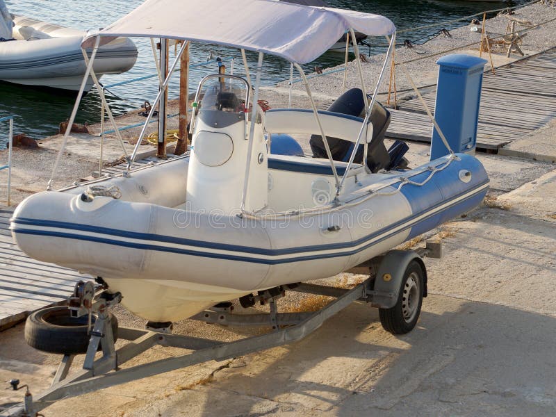 Inflatable Boat with a Motor on a Car Trailer on the Pier Stock Image