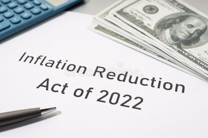 Inflation reduction Act concept. Document, dollar banknotes and calculator on desk stock image