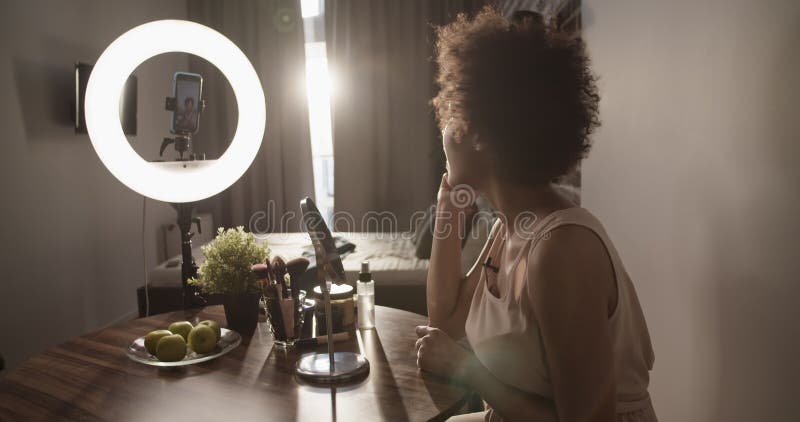 Influenceur américain africain appliquer lipgloss et parler à l'audience clips vidéos