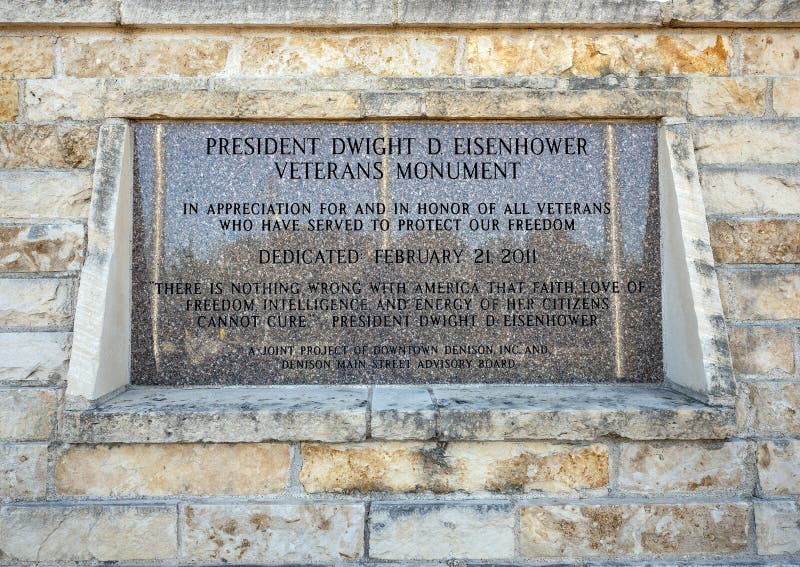 Pictured is the information plaque for the memorial where sits a seventeen foot tall bust of General Dwight David Eisenhower, 34th President of the United States.  The artist is David Adickes who has done busts for all forty-four United States Presidents.  The white concrete image of Eisenhower found a permanent home in Denison at the President Dwight D. Eisenhower Veteran`s Monument dedicated February 21, 2011.  American flags as well as the flags of the Army, Marines, Navy, Air Force and a dedication flag in honor of Deno Maggi, United States Army 1942 - 1945, are flying in the background.  Eisenhower was born in Denison in 1890. Pictured is the information plaque for the memorial where sits a seventeen foot tall bust of General Dwight David Eisenhower, 34th President of the United States.  The artist is David Adickes who has done busts for all forty-four United States Presidents.  The white concrete image of Eisenhower found a permanent home in Denison at the President Dwight D. Eisenhower Veteran`s Monument dedicated February 21, 2011.  American flags as well as the flags of the Army, Marines, Navy, Air Force and a dedication flag in honor of Deno Maggi, United States Army 1942 - 1945, are flying in the background.  Eisenhower was born in Denison in 1890.