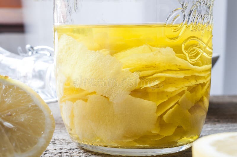 Infused lemon peels in a jar of alcohol for the production of homemade limoncello.