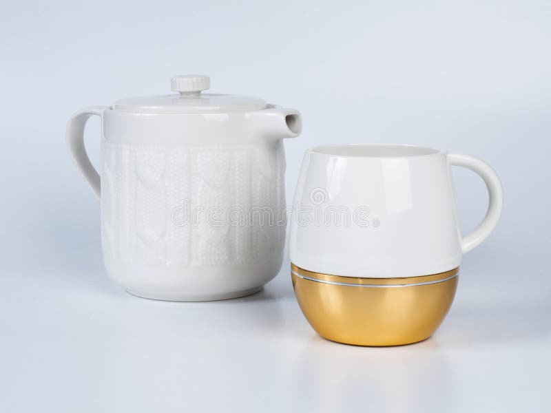 Infuser teapot with tea cup on white background.