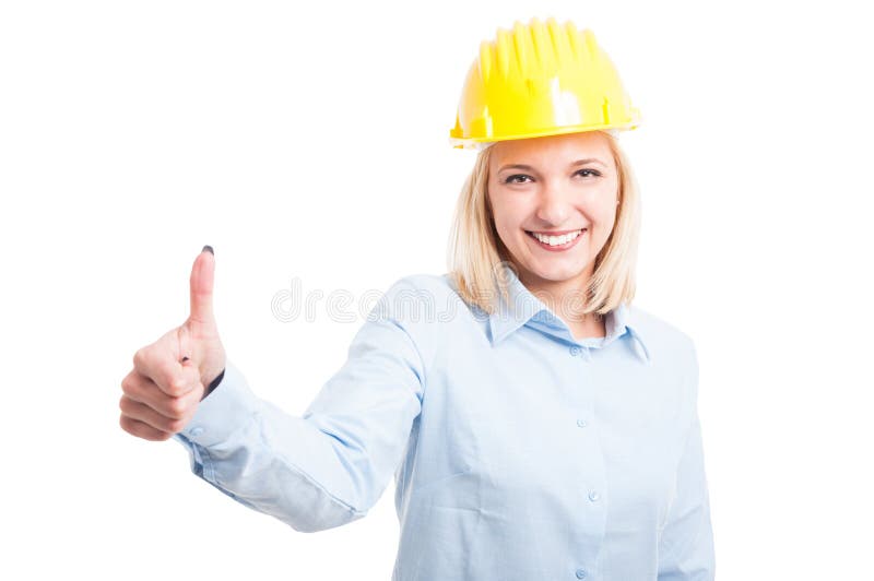 Ingegnere femminile che mostra come il gesto e sorridere immagine stock Ingegnere femminile che mostra come il gesto e sorridere immagine stock