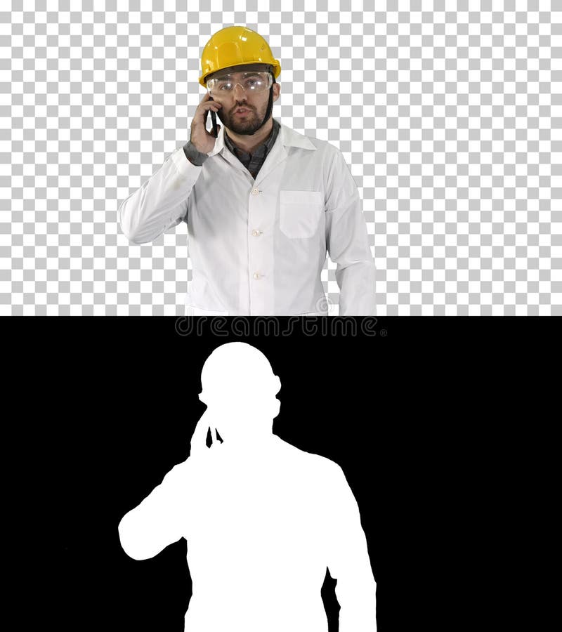 Ingeniero en vidrios protectores y caminar del sombrero, tomando en el tel?fono, Alpha Channel imagenes de archivo Ingeniero en vidrios protectores y caminar del sombrero, tomando en el tel?fono, Alpha Channel imagenes de archivo