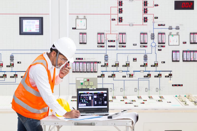 Inginer electric care lucrează în camera de control a centralei termice stock images