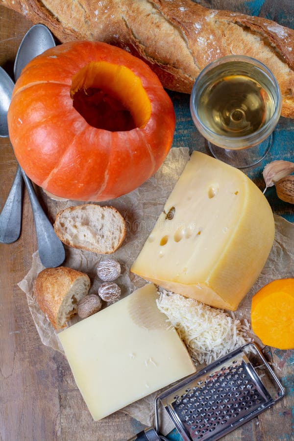 Ingrediens για το παραδοσιακό εποχιακό ελβετικό πιάτο, fondue κολοκύθας με τα τυριά gruyer και έμενταλ, άσπρο κρασί, φρέσκο creme στοκ φωτογραφία Ingrediens για το παραδοσιακό εποχιακό ελβετικό πιάτο, fondue κολοκύθας με τα τυριά gruyer και έμενταλ, άσπρο κρασί, φρέσκο creme στοκ φωτογραφία