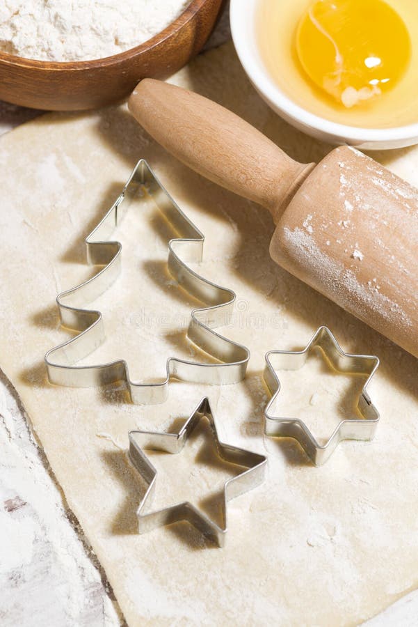 Ingredienser för att baka julkakor på tabellen Deg, kakaskärare och kavel, bästa sikt royaltyfri foto Ingredienser för att baka julkakor på tabellen Deg, kakaskärare och kavel, bästa sikt royaltyfri foto