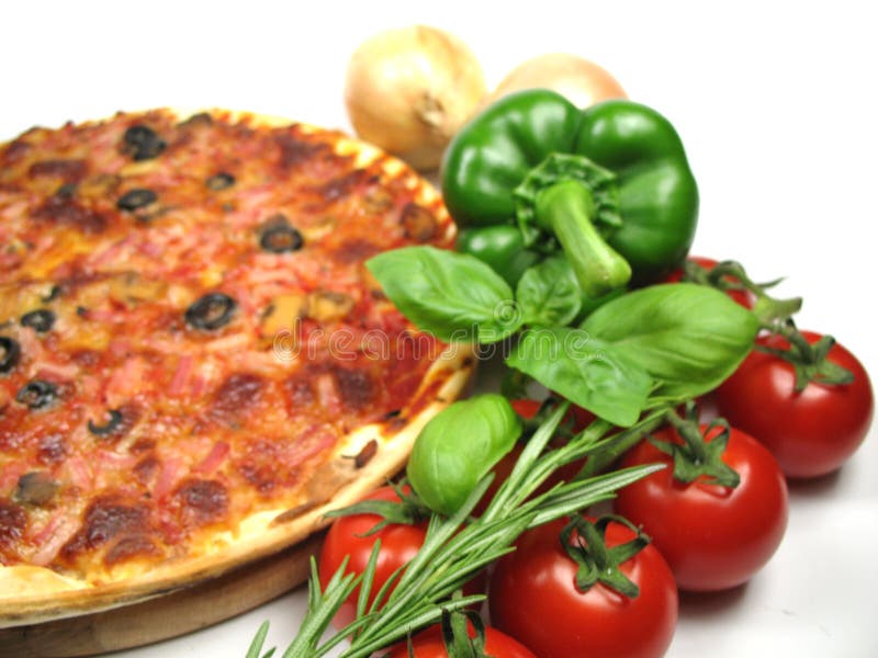 A delicious homemade pizza and some ingredients. A delicious homemade pizza and some ingredients