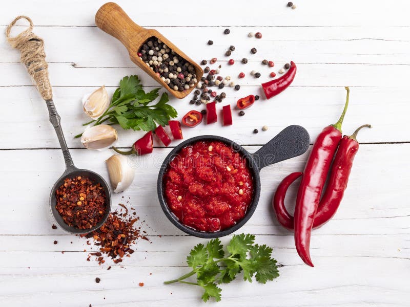 Red hot sauce pepper, ingredients, spices on a white wooden surface. Red hot sauce pepper, ingredients, spices on a white wooden surface.