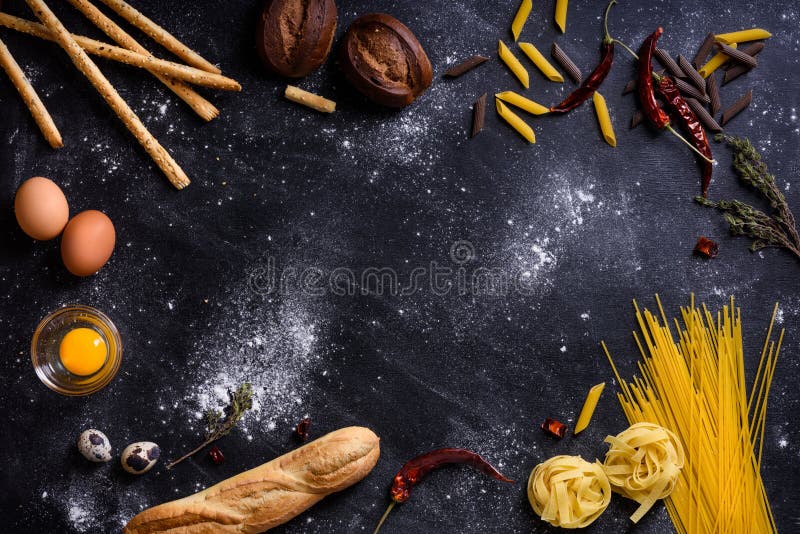 Ingredientes italianos da culinária - espaguetes da massa no fundo escuro fotografia de stock Ingredientes italianos da culinária - espaguetes da massa no fundo escuro fotografia de stock