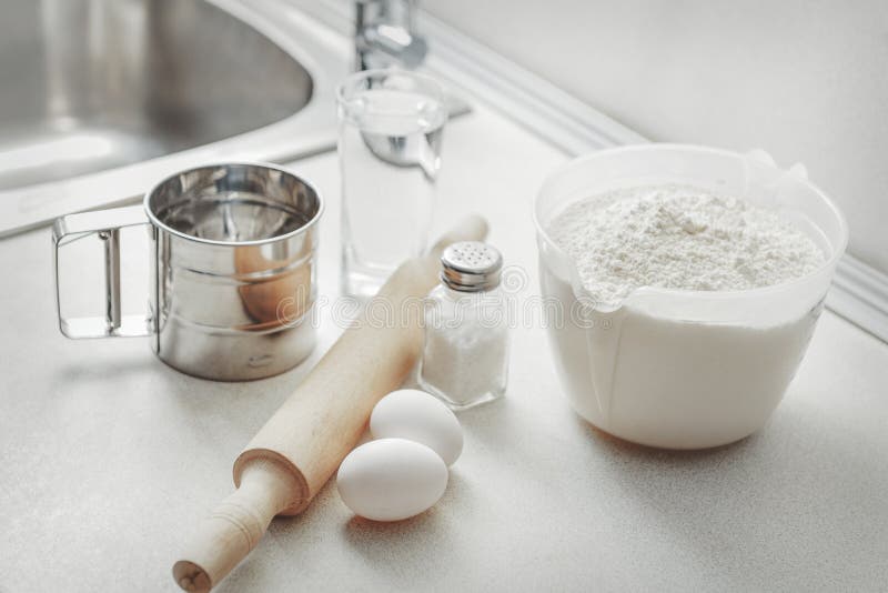 Ingredients for Baking Fresh Bread and Cake. Flour, Eggs, Beater