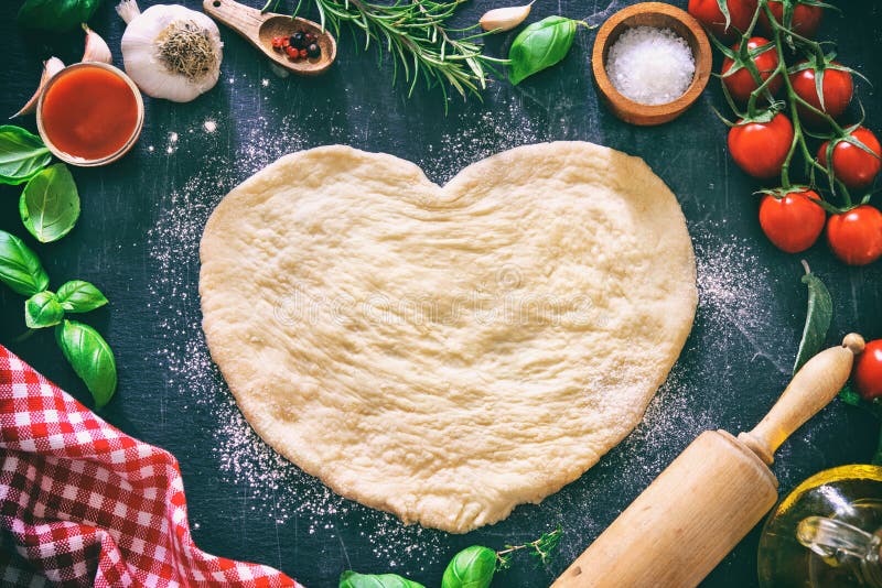 Ingredients for cooking pizza or pasta with dough in heart shape