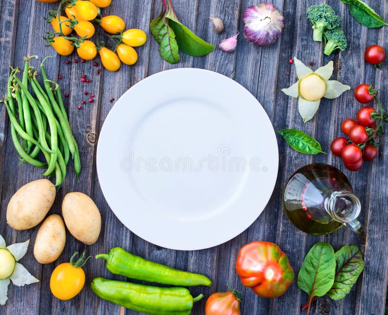 Ingredients for cooking on rustic wooden table around empty whit stock photos Ingredients for cooking on rustic wooden table around empty whit stock photos