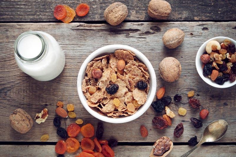 Ingredients for healthy breakfast: cereal wheat flakes and dried fruits royalty free stock photography