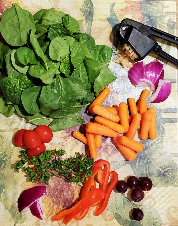 Ingredients for a healthy vegetable soup. Lifestyle, carrots, pepper, garlic, press, grapes, purple, tomatoes, spinach, onion, sliced, food, veggies, fresh royalty free stock photos Ingredients for a healthy vegetable soup. Lifestyle, carrots, pepper, garlic, press, grapes, purple, tomatoes, spinach, onion, sliced, food, veggies, fresh royalty free stock photos
