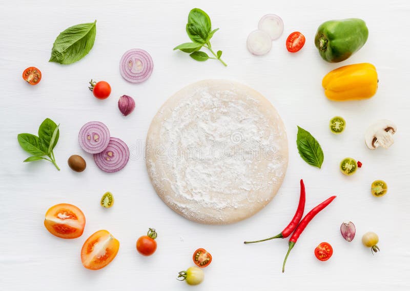 The ingredients for homemade pizza on wooden background