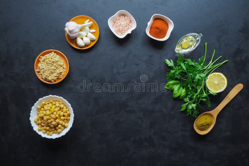 Ingredients for hummus on the black kitchen table. Top view.