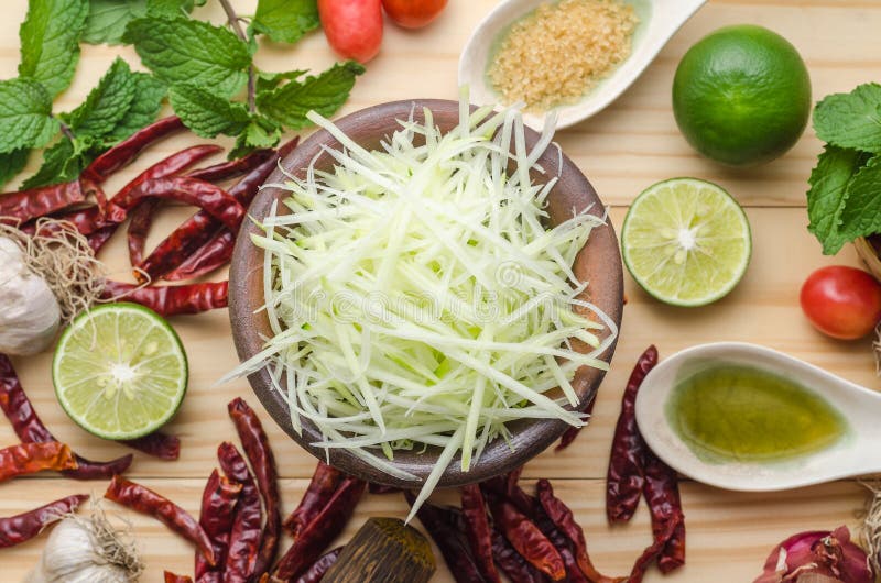 Ingredients for making papaya salad on a wooden table. Set of Th