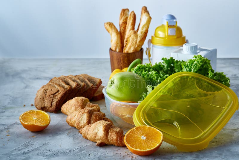 Ingredients for school lunch and plastic container on the table, close-up, selective focus