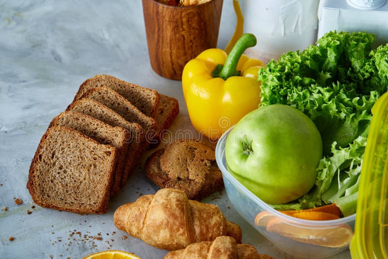 Ingredients for school lunch and plastic container on the table, close-up, selective focus