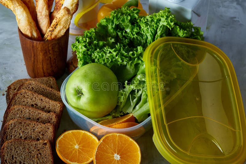 Ingredients for school lunch and plastic container on the table, close-up, selective focus