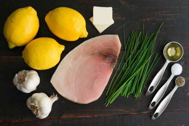 Swordfish steak, lemons, chives, and other ingredients used to make Lemon Garlic Swordfish. Swordfish steak, lemons, chives, and other ingredients used to make Lemon Garlic Swordfish