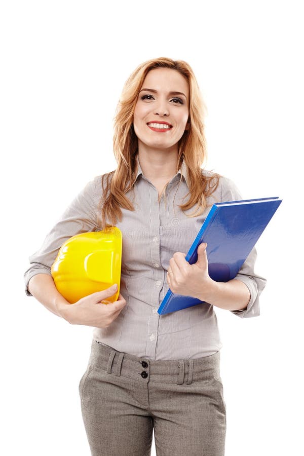 Ingénieur de femme tenant un plan de construction et un casque photographie stock Ingénieur de femme tenant un plan de construction et un casque photographie stock
