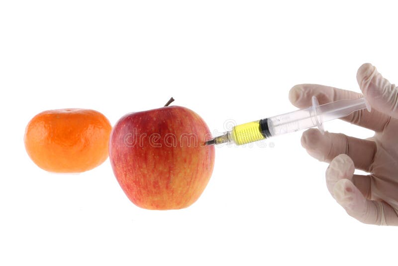 Injection into an apple. A hand in a medical glove with a syringe on a White background. Genetic modified foods. Injection of GMOs