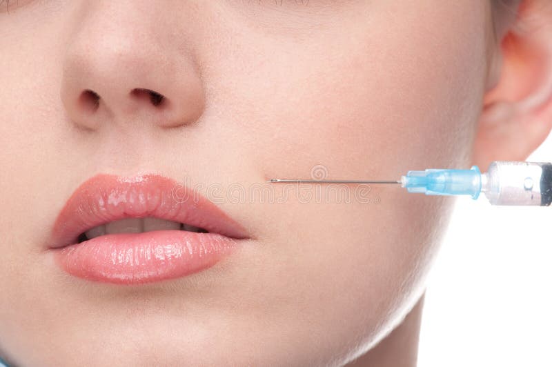 Injection of botox to the face of beautiful woman stock images Injection of botox to the face of beautiful woman stock images