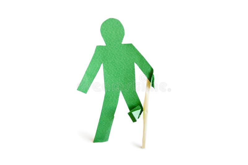An injured green stick figure with a walking stick over white background royalty free stock images