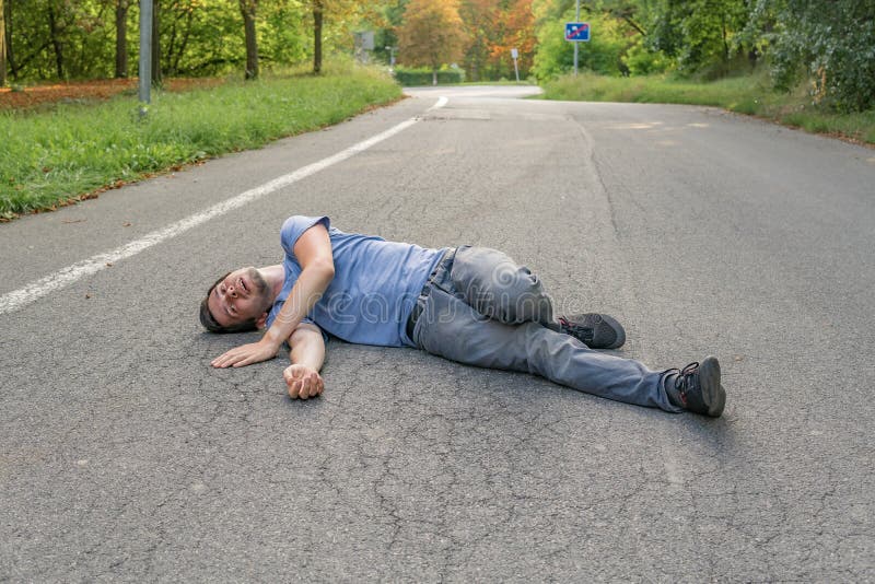 Injured Man Had an Accident and is Lying on Road Stock Photo Image of trauma, wound 110793994