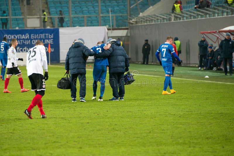 The injured player being taken away from the field