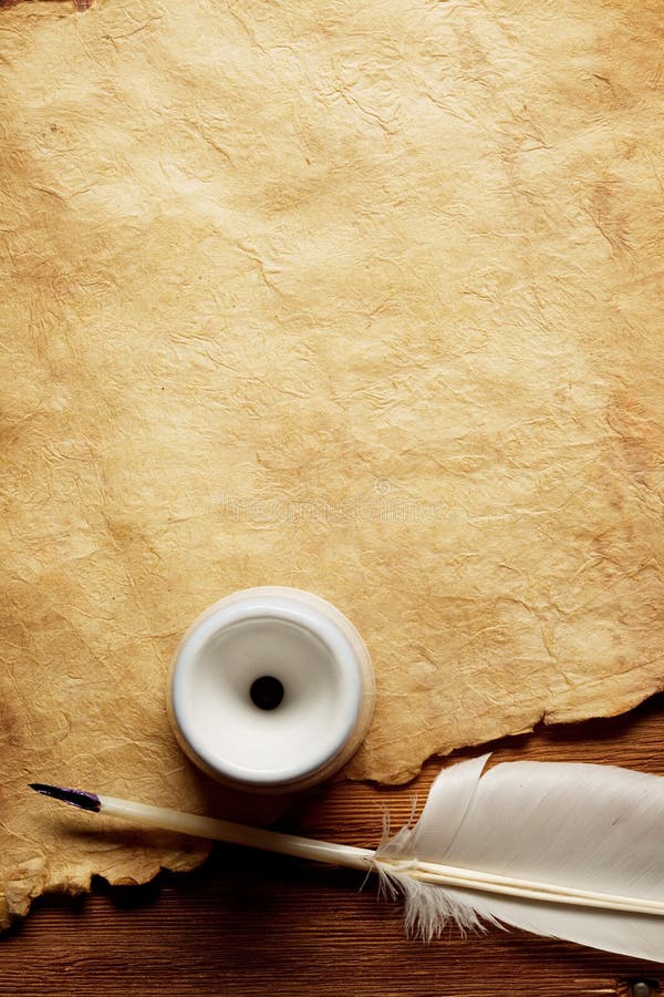 Inkwell and feather on a old paper royalty free stock images