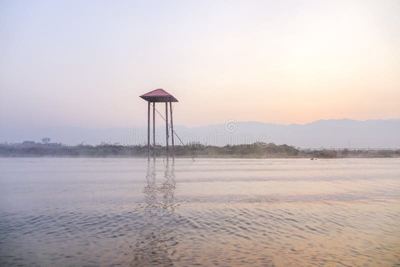 The sunset on Inle Lake, Shan, Myanmar. One leg paddling is the unique rowing style in Myanmar.The reason for this way of paddling is because there are many reeds and water plants in the lake, and if they row sitting down in the boat they can’t see them. Fishermen in Myanmar have a conical net to catch fish and this net is made from bamboo or cane. Inle Lake is the second largest lake in Myanmar with an estimated surface area of 44.9 square miles 116 km2, and one of the highest at an elevation of 2,900 feet 880 m. Myanmar is also the famous destination to travel and attracts many tourists in the world.