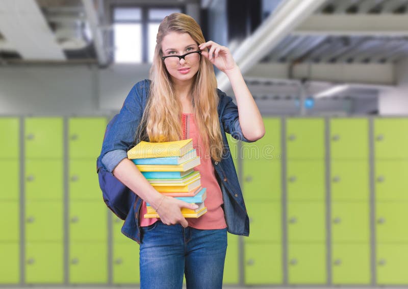 Digital composite of female student holding books in front of lockers. Digital composite of female student holding books in front of lockers