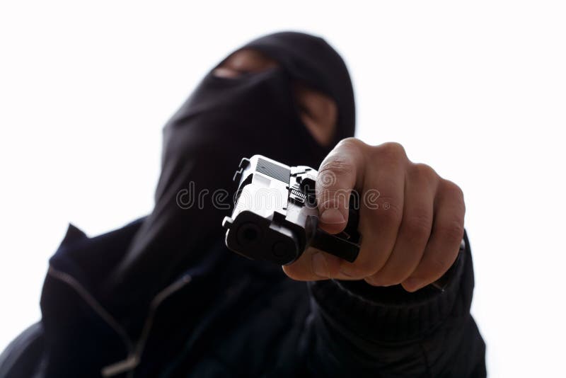 A masked man aiming his gun holding the trigger. A masked man aiming his gun holding the trigger