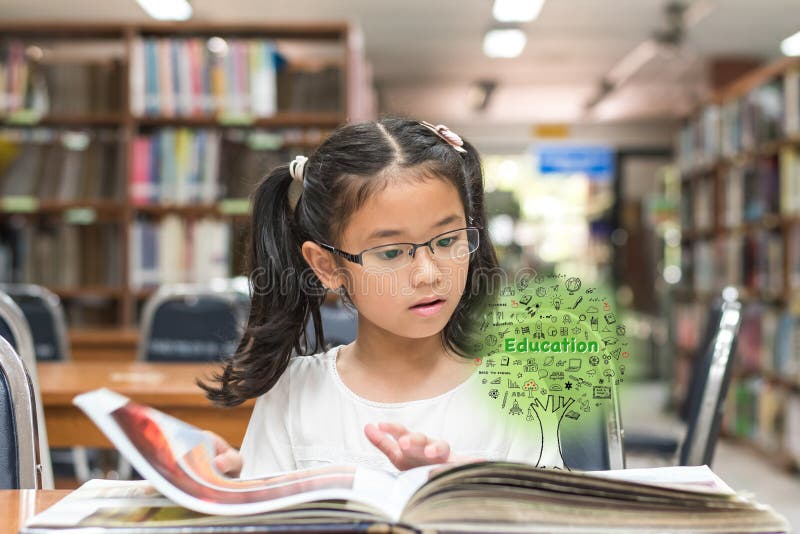 Innovative stem education and tree of knowledge concept with kid reading book in library royalty free stock photos