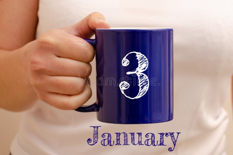 The inscription on the blue cup 3 january. Cup in female hand, business concept