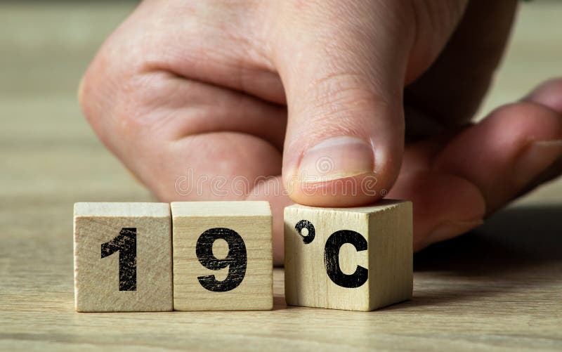 Inscription 19 Celsius on wooden blocks with a finger turning the blocks. 19 Celsius word royalty free stock photo