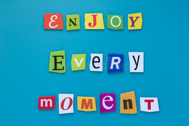 Inscription from cut letters - enjoy every moment on blue background. A word writing text showing enjoy every moment. Concept posi royalty free stock photos