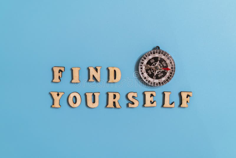 Inscription find yourself and compass on a blue background. concept of asserting oneself in life and finding your destiny. royalty free stock photography