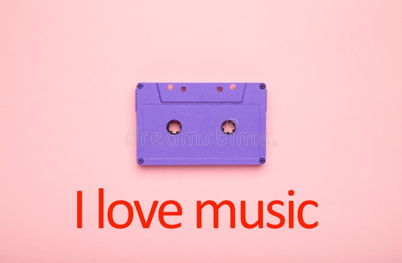 Inscription I love music with old colorful cassette on a pink background. Music day stock images Inscription I love music with old colorful cassette on a pink background. Music day stock images