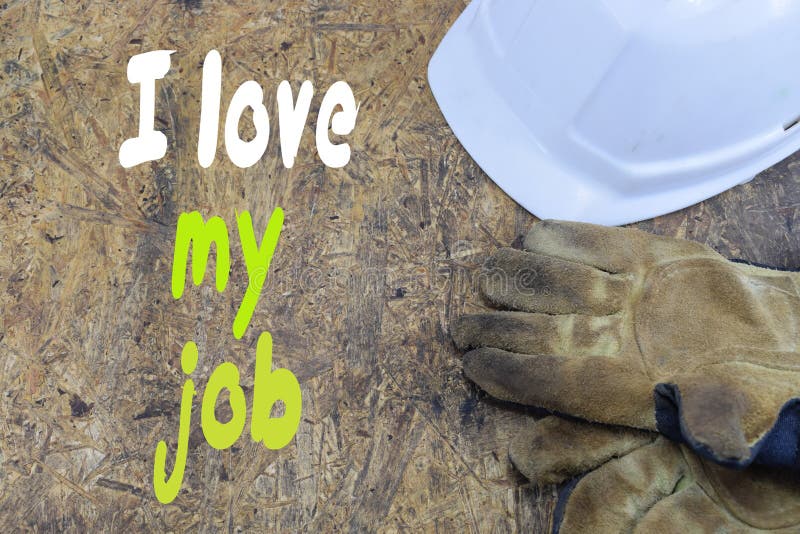 Inscription, I love my job, against the background of a white helmet of a builder with working gloves royalty free stock image Inscription, I love my job, against the background of a white helmet of a builder with working gloves royalty free stock image