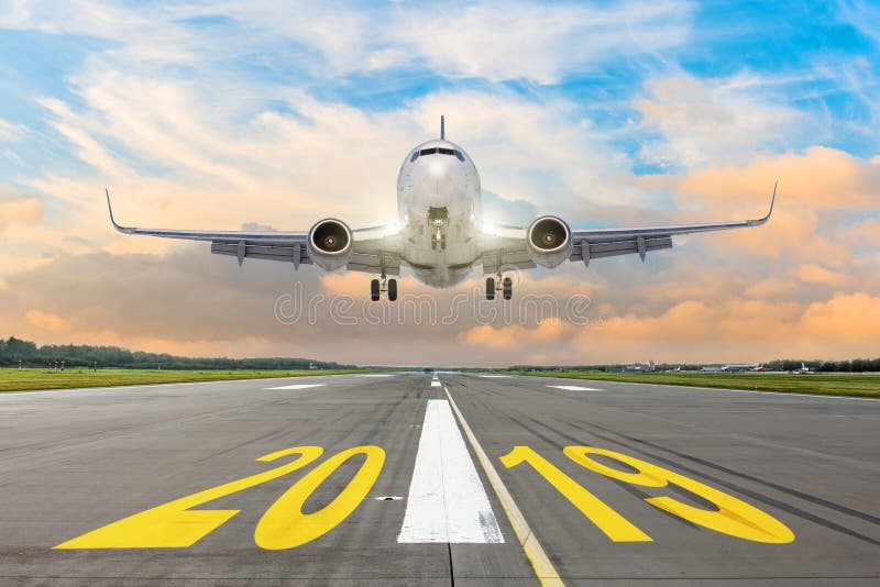 The inscription on the runway 2019, plane taking off. The concept of travel in the new year, holidays. stock image The inscription on the runway 2019, plane taking off. The concept of travel in the new year, holidays. stock image