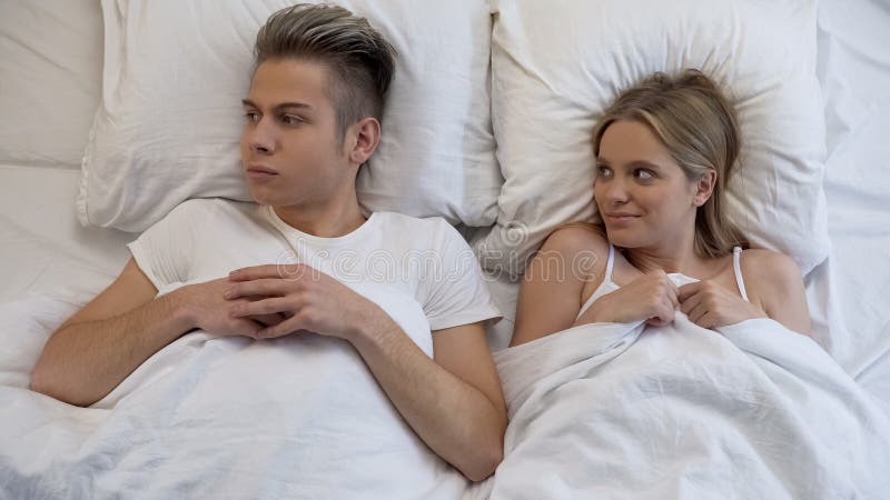 Insecure Young Man Feeling Scared before First Sex with Girlfriend, Panic Stock Photo